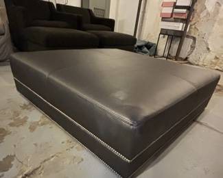 Large leather ottoman on wheels. 48" D x 48" W x 13" H.