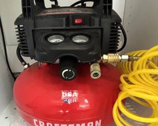 Craftsman 6-gallon pancake air compressor w/hose attachment.