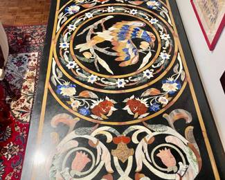Black marble with hand laid precious stones