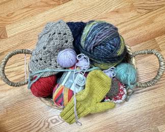 Assorted Yarn and Hand-Knitted Items in Wicker Basket