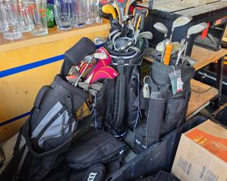 three sets of golf clubs