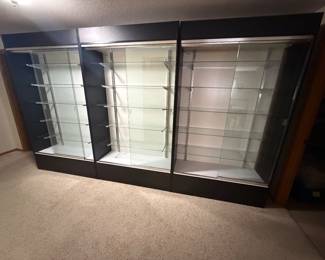 3 BLACK WALL UNIT DISPLAY CASES W/LIGHTS. WILL BE SOLD SEPERATELY