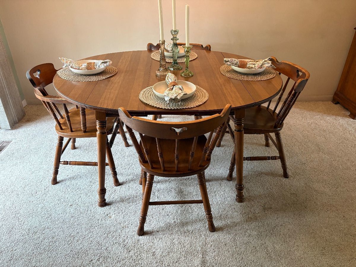 Dining room table with 1 extension lead shown. 3 more leaves included. Sides of table drop down. 6 match chairs