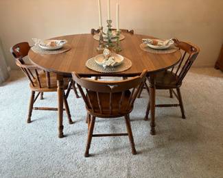 Dining room table with 1 extension lead shown. 3 more leaves included. Sides of table drop down. 6 match chairs 