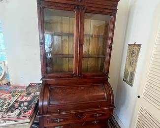 Civil War-Era Victorian Secretary Desk & Bookcase — c. 1860s Impressive antique Victorian secretary featuring a glass-front bookcase over a cylinder/roll-top writing desk with multiple lower drawers. Beautiful warm wood, ornate period detailing, original character and substantial proportions. An exceptional statement piece believed to date to the Civil War era