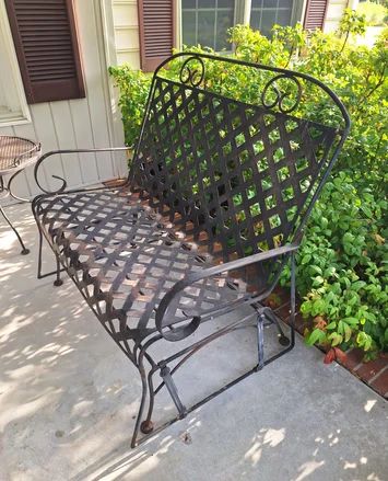 Wrought iron glider, one of several pieces of wrought iron outdoor patio furniture