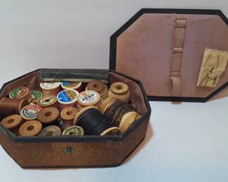 Antique sewing box with wooden spools of thread
