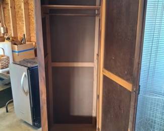 Small wardrobe with dowel rod and top shelf