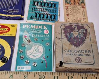 Vintage cards and boxes of sewing supplies, needles, snaps and hooks