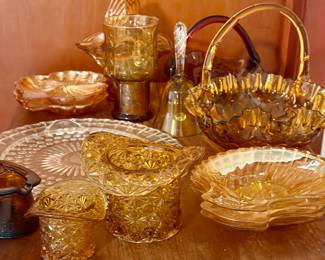 Amber and golden-hued vintage glass collection featuring pressed-glass bowls, serving plates, snack dishes, baskets, compotes, and decorative pieces. A lovely mix of patterns and sizes for collectors, entertaining, or fall décor.