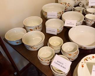 Vintage Hall’s Autumn Leaf dinnerware collection in the classic ivory, gold, and rust floral pattern. Includes plates, bowls, cups and saucers, pitchers, cream-and-sugar pieces, serving bowls, platters, and additional matching serving ware.