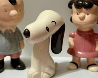 Vintage Peanuts / Charlie Brown ceramic figurine collection, featuring Charlie Brown, Lucy, and Snoopy. Charming display pieces for a Peanuts fan or character-collectible collection.
