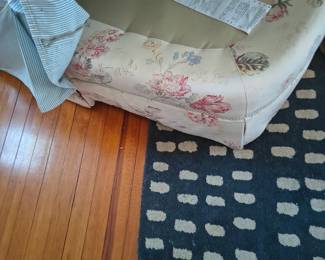 Pristine white slip cover over toile/top quality sofa