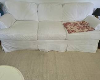 Top quality slip covered feather stuffed sofa in pristine condition. 86" by 36" by 39"