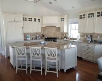 Chef's kitchen with ample upper & lower cabinetry plus an island. 3 bar stools available