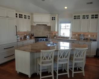 Chef's kitchen with Sub-Zero refrigerator; custom range hood