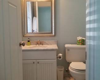 Bath vanity; mirror; vanity lights; toilet