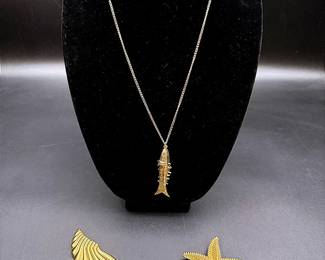 A Monet Starfish Pin, A Gold-toned Shell Brooch & An Articulated Fish Pendant Necklace