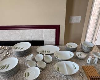 Noritake “Sugi” pattern #6030, made in Japan. It’s the white Mid-Century Modern pattern with the green leaf motif and gray edging.