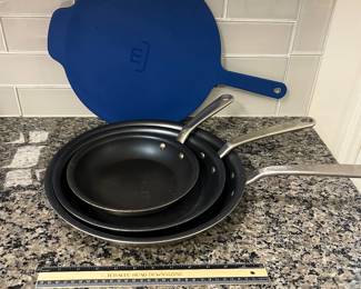 H96 - $85. 4 Piece Set. Made - In Fying Pan Set with Universal Lid. They show signs of wear.