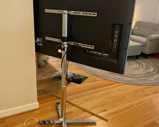 H24 - $120. 55” Vizio TV Model M55-C2 on Chrome Stand. TV on Stand Measures 59.5” Tall.