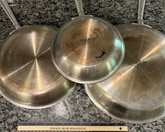 H96 - $85. 4 Piece Set. Made - In Fying Pan Set with Universal Lid. They show signs of wear.