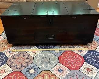 H49 - $95. Trunk Style Coffee Table - Dark Finish. Measures 44” W x 24” D x 18” Tall. Very good, Gently used condition.