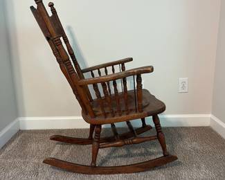 H61 - $65. Antique Rocking Chair with leather seat. Measures 25” W x 30“ D x floor to seat 16” x floor to back 38.5“ Tall.