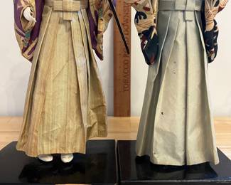 H124 - $60. Pair of Vintage Kurodabush Samurai Dolls. One is missing a thumb. Each Measures 11.5" Tall.