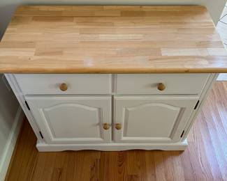 H57 - $60. White Cabinet. Single Drawer with Storage Cabinet below. Measures 38” W x 18” D x 31” Tall.