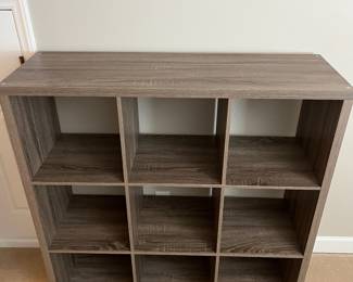 H75 - $30. 9 Cube Bookshelf. Measures 44“ W x 14.5“ D x 44” Tall.