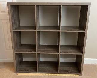 H75 - $30. 9 Cube Bookshelf. Measures 44“ W x 14.5“ D x 44” Tall.