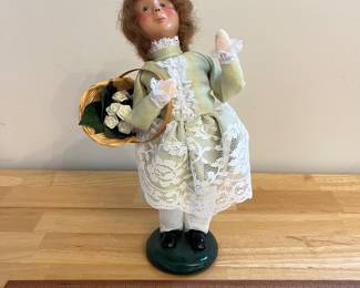 H126 - $40. Signed by Joyce Bayer. Byers' Choice "The Carolers" Lady with Flowers. Measures 9.5" Tall.