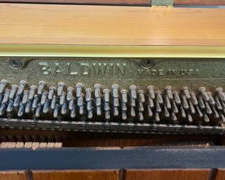 H46 - $100. Baldwin Upright Piano. Serial #1196036. Made In The USA. Measures 59” W x 29” D x 40” Tall. YOU MUST HIRE MOVERS. Located on the first floor - about 20' into the house.