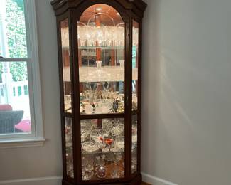 H56 - $225. Lighted Corner Display Cabinet. 3 Adjustable Glass Shelves. Measures 36“ W x 24” D x 78” Tall. Excellent Condition.