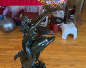 Tiffany-style stained glass floor lamp featuring a sculptural figure of a woman riding a dolphin, topped with a colorful mosaic bowl shade 4Ft tall