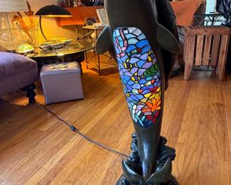 Tiffany-style stained glass floor lamp featuring a sculptural figure of a woman riding a dolphin, topped with a colorful mosaic bowl shade 4Ft tall