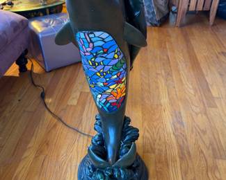 Tiffany-style stained glass floor lamp featuring a sculptural figure of a woman riding a dolphin, topped with a colorful mosaic bowl shade 4Ft tall