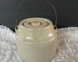 vintage stoneware crock jar with a matching lid and a metal wire bail handle