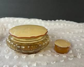 vintage amber glass vanity jar featuring a fluted base and a pale celluloid lid.