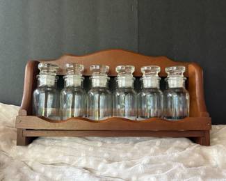 Wooden apothecary shelf with glass bottles