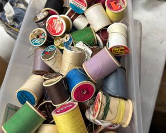 Spools of thread a lot of sewing supplies