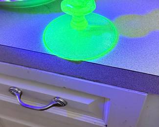 Glowing vintage uranium glass candlestick holder that shines brilliant neon green under UV light a must-see find for glassware collectors! 💚✨