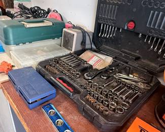 Well-stocked garage finds featuring a large socket-and-wrench set, S-K Tools, levels, toolboxes, and assorted hand tools—perfect for mechanics and DIYers! 🔧🧰