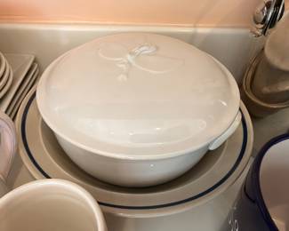 White covered casserole and blue rim dishes