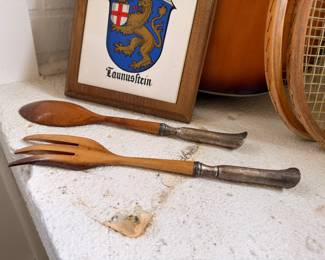 Carved wood salad servers and crest plaque