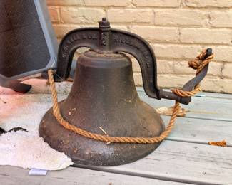 Large antique cast iron farm bell with rope