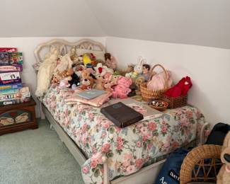 Floral daybed with stuffed animals and games