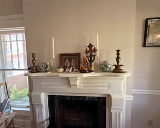 Fireplace mantel with brass candlesticks and Hummel figurines
