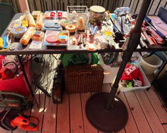 Deck table with household goods and picnic basket